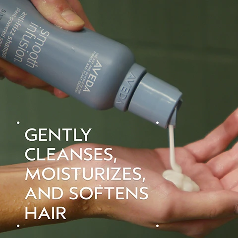 Image 2 - A hand squeezes a light blue Aveda smooth infusion anti-frizz shampoo bottle, dispensing white product into another wet palm, with overlay text that reads GENTLY CLEANSES, MOISTURIZES, AND SOFTENS HAIR. Image 3 - Image shows a split screen with a womans dark hair before and after treatment; the left side, labeled BEFORE Unwashed Hair, displays frizzy, dull hair, while the right side, labeled AFTER, shows smooth, straight, shiny hair, with additional text Results with Smooth Infusion™ Anti-Frizz Shampoo, Conditioner, and Perfect Blow Dry. Blow dried with Wooden Paddle Brush. Image 4 - A dark green graphic with a circular image of an avocado pit submerged in golden oil, with text that reads BOTANICAL SMOOTHING BLEND FEATURES KALAHARI MELON AND TAMANU SEED OILS TO SMOOTH AND CONDITION CUTICLES FOR SOFTNESS AND SHINE. Image 5 - Image showing a three-step hair care guide with circular photos and text descriptions: HOW TO USE, 01 CLEANSE, a person shampooing their hair, Smooth Infusion Anti-Frizz Shampoo; 02 CONDITION, conditioner being dispensed into a hand, Smooth Infusion Anti-Frizz Conditioner; 03 STYLE, a styling spray bottle and a paddle brush, Smooth Infusion Perfect Blow Dry & Wooden Paddle Brush. Image 6 - A swirl of thick white cream or lotion with a smooth texture against a white background. Image 7 - The image displays three white certification logos against a background of dark green tropical leaves and a red plant stalk, featuring a circular 100% VEGAN logo with a large V, a Certified B Corporation logo with a B in a circle, and a Cruelty Free International logo with a leaping rabbit.