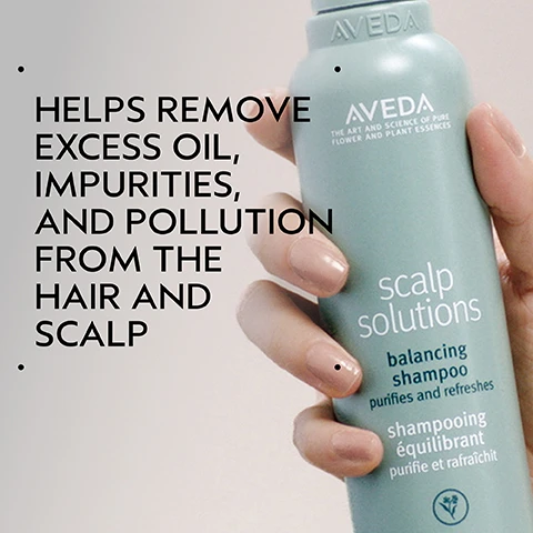 Image 2 - A hand holds a light blue bottle of Aveda Scalp Solutions Balancing Shampoo, with text on the left stating HELPS REMOVE EXCESS OIL, IMPURITIES, AND POLLUTION FROM THE HAIR AND SCALP, and text on the bottle reading AVEDA THE ART AND SCIENCE OF PURE FLOWER AND PLANT ESSENCES scalp solutions balancing shampoo purifies and refreshes shampooing équilibrant purifie et rafraîchit. Image 3 - A before and after comparison shows a womans long dark hair appearing frizzy and dull on the left, labeled BEFORE Unwashed Hair, and then smooth, shiny, and well-styled on the right, labeled AFTER Results with Scalp Solutions Exfoliating Scalp Treatment, Balancing Shampoo, Replenishing Conditioner, Hydrating Hair & Scalp Masque and Overnight Scalp Renewal Serum. Styled with Pure Abundance Style-prep™ and Air Control™ Light Hold Hair Spray. Image 4 - A dark green graphic features a white circle containing a cross-section of an orange, slices of bergamot, green mint leaves, and white citrus blossoms with an orange peel accent, with the visible text CLEAN, UPLIFTING AROMA and BRIGHT CITRUS NOTES OF LEMON AND ORANGE WITH NEROLI AND CRISP, COOL MINT. Image 5 - An infographic outlining a four-step scalp care routine, featuring circular images that show applying an exfoliating treatment to the scalp, massaging the scalp with a tool, cleansing and conditioning hair, and applying a serum with a dropper, with visible text that reads: HOW TO USE, 01 EXFOLIATE Scalp Solutions Exfoliating Scalp Treatment, 02 MASSAGE Scalp Solutions Stimulating Scalp Massager, 03 CLEANSE & CONDITION Scalp Solutions Balancing Shampoo & Replenishing Conditioner, 04 TREAT & REFRESH Scalp Solutions Overnight Scalp Renewal Serum, Hydrating Hair and Scalp Masque & Refreshing Protective Mist. Image 6 - A split-screen image shows the back of a persons head with dark, wavy hair before and after treatment, featuring unwashed, frizzy hair on the left labeled BEFORE and clean, defined, styled hair on the right labeled AFTER, with visible text reading Unwashed Hair and Results with Scalp Solutions Exfoliating Scalp Treatment, Balancing Shampoo, Hydrating Scalp & Hair Masque, Refreshing Protective Mist, Overnight Repair Serum. Styled with Aveda Men Pure-formance™ Pomade, Texture Tonic, Light Elements Defining Whip, and Air Control™ Light Hold Hair Spray. Image 7 - Close-up of white foam with many bubbles of varying sizes. Image 8 - A background of dark green tropical leaves with a red plant stem on the left, displaying three white certification logos: a circular logo with a V and the text 100% VEGAN, a Certified B Corporation logo with a B in a circle, and the Cruelty Free International logo featuring a leaping bunny.