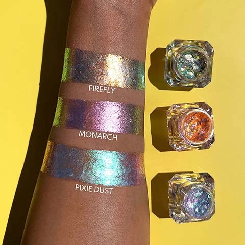 Image 1, swatches of product, firefly, monarch and pixie dust. Image 2, 3 ways to wear infinite chrome flakes, fall out free, no mixing medium required. soft sparkle effect - for a natural glimmer apply a small amount with finger, tap to beldn, let dry for a few seconds. scattered foil effect, apply a small amount using a flat synthetic brush and tap to scatter glitter. let dry for 20 seconds. full foil effect, apply using flat synthetic brush and swipe for ultimate infinite chrome drama, let dry for 30 seconds. best applied in thin layer, always allow a moment to dry. Image 3, one shade, 2 different lightings, infinite chrome flakes.