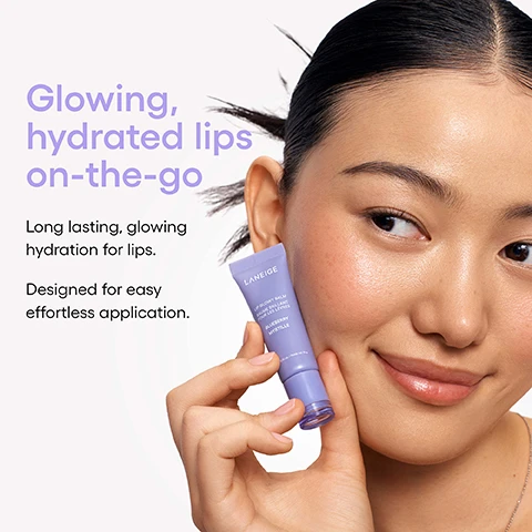 Image 1 - A woman with glowing skin smiles while holding a purple tube of LANEIGE LIP GLOWY BALM BAUME BRILLANT POUR LES LEVRES BLUEBERRY MYRTILLE 0.35 oz. / Poids net 10 g near her cheek, with text that reads Glowing, hydrated lips on-the-go, Long lasting, glowing hydration for lips, and Designed for easy effortless application. Image 2 - A purple tube of LANEIGE Lip Glowy Balm Blueberry sits among several blueberries and a product swirl, with text reading Lips as smooth as butter, Infused with two blends of butter for the smoothness your lips crave, Shea Butter to nourish, and Murumuru Seed Butter to hydrate. Image 3 - A graphic displays product survey results and scattered blueberries, with the text BUTTER UP, THEN PUCKER UP! After 1 Week of Use, 98% Agreed lips look glossy & feel smoother, 96% Agreed lips feel nourished, 94% Agreed lips feel well-hydrated, and 92% Agreed lips look less flaky. Image 4 - Seven colorful lip gloss bottles, each with a dollop of gloss on its applicator, are displayed with text that reads Glossing 10 million* lips worldwide! and *Period: 2017 - 2023, along with small inverted product weight details on the bottles.
