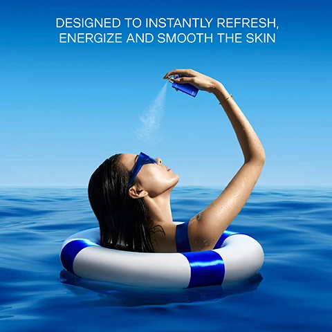 Image 1 - A person with long dark hair wearing sunglasses is relaxing in a blue swimming pool while spraying a product on their face, with the text DESIGNED TO INSTANTLY REFRESH, ENERGIZE AND SMOOTH THE SKIN displayed above.
Image 2 - An artistic illustration of blue water droplets on a blue background with a single yellow droplet in the center, accompanied by the text INFUSED WITH CAVIAR HYDROESSENCE AND CAVIAR MICRO-NUTRIENTS.
Image 3 - Image of a smooth, glossy white circular droplet with smaller translucent droplets surrounding it on a light background, featuring the text THE HIGH-TECH NANO-EMULSION FORMULA SEALS IN HYDRATION.
Image 4 - A woman wearing blue sunglasses and a blue swimsuit holds a spray bottle while standing in front of a blue ocean, with a white and blue lifebuoy around her arm; the visible text reads SPRITZ ONTO FACE AS DESIRED THROUGHOUT THE DAY.
Image 5 - A collection of skincare products from La Prairie, including bottles and jars in blue packaging, arranged on ice inside a round blue container, with the text FITS INTO ANY LA PRAIRIE RITUAL ANY TIME OF DAY displayed in white below.