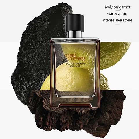 Image 1 - A perfume bottle labeled Terre dHermes Eau de Parfum Intense is placed on textured wood and surrounded by yellow citrus fruits and black volcanic rock, with the words lively bergamot, warm wood, and intense lava stone displayed nearby.
Image 2 - A lineup of five perfume bottles labeled Terre dHermès, displayed on white pedestals, with visible text indicating the scent profiles for each: Terre dHermès Eau de Toilette (grapefruit, cedar, flint), Terre dHermès Eau Givrée (cedrat, juniper berry, Timut pepper), Terre dHermès Eau de Parfum Intense (lively bergamot, warm wood, intense lava stone), Terre dHermès Eau Intense Vétiver (green bergamot, Sichuan pepper, vetiver), and Terre dHermès Parfum (grapefruit, cedar, shiso).