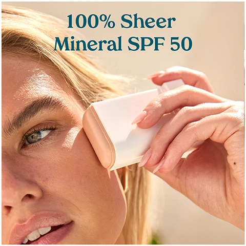 Image 1 - A close-up of a person applying a sunscreen stick to their face, with the text 100% Sheer Mineral SPF 50 above the image.
Image 2 - A person with long hair holds a white sunscreen stick near their collarbone, displaying glowing skin and wearing a turquoise top, with text that reads Hydrating mineral SPF, Glides on sheer, For face & body.
Image 3 - A woman with long, wavy brown hair smiles at the camera while holding a white skincare product labeled Kohari in her right hand.
Image 4 - A sun protection stick is displayed against a soft background with a flower, featuring text that highlights key benefits: Mineral SPF UVA/UVB, Moisturizing Bisabolol, and Soothing Vitamin E.
Image 5 - Three skincare products are displayed on a gradient background, labeled as part of the Mineral SPF Collection: an On-The-Go Stick with SPF 50, a Dewy Face lotion with SPF 30, and a Brightening Face cream with SPF 50, all featuring the brand name KOPARI.
Image 6 - A person holding a spray bottle of Ultra-Fine SPF 30 Glow Mist, applying it to their chest, which is partly covered by a gold bikini top, with text above that reads Ultra-Fine SPF 30 Glow Mist.