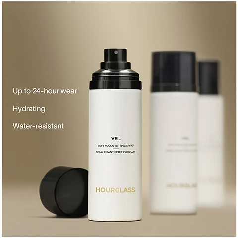 Image 1 - A sleek bottle of Hourglass Veil Soft Focus Setting Spray is in the foreground, with two additional similar bottles slightly blurred in the background, and the text reads Up to 24-hour wear, Hydrating, Water-resistant.
Image 2 - A model with long dark hair and a neutral makeup look is holding a white bottle of Hourglass cosmetic product, with text on the left stating 100% said formula felt weightless and undetectable and 97% said skin instantly looked smoother and more even.