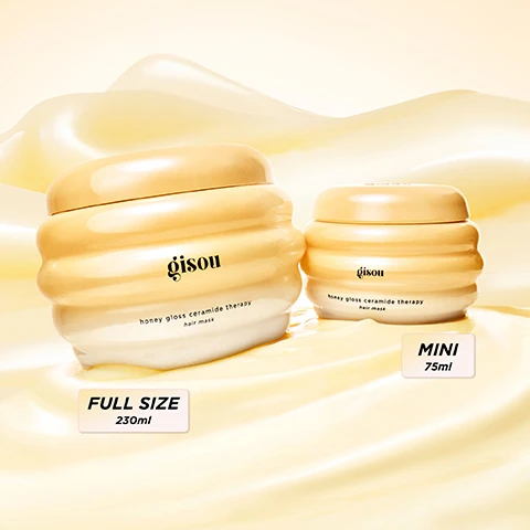 Image 2 - Two jars of Gisou Honey Gloss Ceramide Therapy hair mask are displayed, one larger jar labeled FULL SIZE 230ml and one smaller jar labeled MINI 75ml, both resting on a smooth, creamy background.
Image 3 - A woman with long, wavy hair holds a yellow jar while looking confidently at the camera, with text on the image highlighting benefits like 19X smoother hair, 4X stronger hair, +85% shinier hair, and 72H frizz reduction, and the phrase CLINICALLY PROVEN* at the top.
Image 4 - A comparison image showing textured black hair, with the left side labeled BEFORE displaying loose and frizzy curls and the right side labeled AFTER showing defined and shiny curls.
Image 5 - Image showing a comparison of hair texture: on the left labeled BEFORE, the hair appears frizzy and unkempt, while on the right labeled AFTER, the hair looks smooth and shiny.
Image 6 - A golden hair mask jar with a creamy texture is displayed alongside honeycomb, featuring text that highlights intense hydration, strength, and gloss, with bullet points on ingredients including Mirsalehi honey, Hyaluronic acid, Biomimetic ceramides, and Antioxidant Keraguard.
Image 7 - An image of a creamy hair mask with a yellow background and instructions on how to use it, including the steps: apply generously to damp or dry hair from lengths to ends, let sit for 5-7 minutes, and rinse thoroughly, with a note at the bottom suggesting to mix in 2-3 drops of Honey Infused Hair Oil for an extra-hydrating treatment.
Image 8 - Image shows a promotional graphic for a three-step honey hydration routine, featuring a hair mask, a hair oil, and a hair perfume, with the text: YOUR 3-STEP HONEY HYDRATION ROUTINE, 1: TREAT, HONEY GLOSS CERAMIDE THERAPY HAIR MASK, 2: SHINE, HONEY INFUSED HAIR OIL, 3: SCENT, HONEY INFUSED HAIR PERFUME.