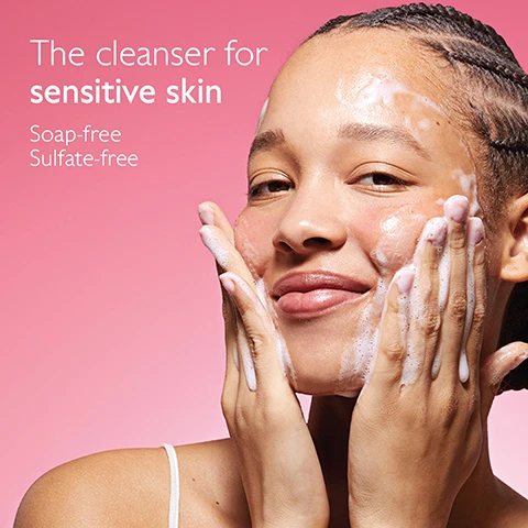 Image 1 - A young woman smiles while washing her face with a foaming cleanser against a pink background, with text that reads The cleanser for sensitive skin, Soap-free, Sulfate-free. Image 2 - A person with short blonde hair smiles, with a dollop of white cream on their left cheek, holding a pink Caudalie VinoHydra tube, against a pink background with visible text Dry skin, even sensitive, +94% hydration after 8 hours*, and on the product tube Caudalie Paris, VinoHydra Crème Hydratation Intense, Acide Hyaluronique, Eau de Raisin, Beurre de Karité, Deep Hydration Moisturizer, Hyaluronic Acid, Organic Grape Water, Shea Butter, 2.0 Fl. Oz., and a small disclaimer *Instrumental test. Corneometry. 10 volunteers.