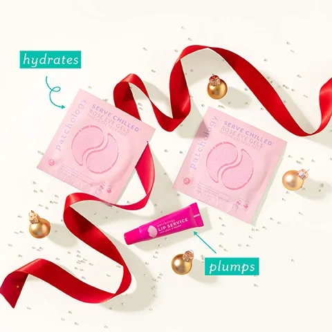 Image 2 - Two pink packets of Patchology Serve Chilled Rose Eye Gels Patches Gel Yeux Rosé and a pink tube of Patchology Lip Service Soin Gloss & Baume are decoratively arranged on a white surface with a red ribbon, small gold ornaments, and scattered glitter, with annotations reading hydrates for the eye gels and plumps for the lip service.