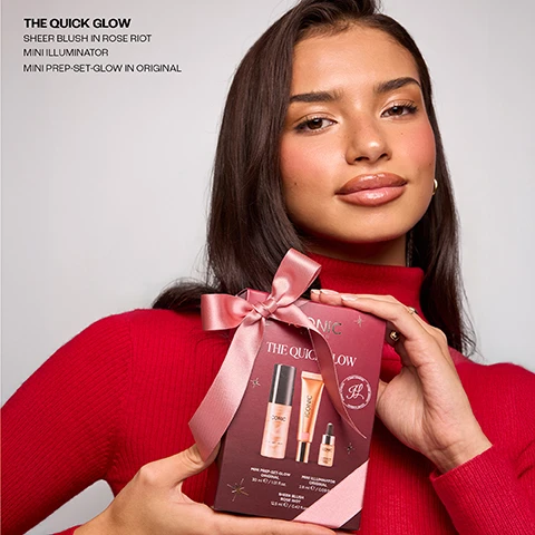 Image 2 - A woman with dark hair, luminous skin, and glossy lips, wearing a red turtleneck sweater, holds a reddish-brown gift box tied with a pink satin ribbon, with the visible text THE QUICK GLOW SHEER BLUSH IN ROSE RIOT MINI ILLUMINATOR MINI PREP-SET-GLOW IN ORIGINAL ICONIC LONDON THE QUICK GLOW MINI PREP-SET-GLOW ORIGINAL 30 ml e / 1.01 fl.oz. MINI ILLUMINATOR ORIGINAL 2.8 ml e / 0.09 fl.oz. SHEER BLUSH ROSE RIOT 12.5 ml e / 0.42 fl.oz. Image 3 - A stack of cream and maroon Iconic London gift boxes, the cream boxes featuring cursive iconic script and a cream ribbon repeating ICONIC LONDON, displays various makeup products and two gift sets: a maroon box titled ICONIC LONDON THE QUICK GLOW which visibly lists Mini Prep-Set-Glow, Mini Illuminator, and Sheer Blush Rose Riot, and a middle maroon box titled ICONIC LONDON ULTIMATE ICON which visibly lists TRIFLE THREAT MASCARA, GLOW, LUSTRE LIP OIL, ILLUMINATOR, EYE LINER, PREP-SET-GLOW ORIGINAL, UNDERGLOW BLURRING PRIMER, CHEEK GLOW BRUSH, and HEADBAND; the image also includes a separate text block: THE QUICK GLOW SHEER BLUSH IN ROSE RIOT MINI ILLUMINATOR MINI PREP-SET-GLOW IN ORIGINAL. Image 4 - A white background displays three Iconic London glow products: a small dropper bottle, a metallic squeeze tube, and a tall spray bottle, with visible text including The THE QUICK GLOW, MINI ILLUMINATOR OUR MUST- HAVE HIGHLIGHTER WITH OVER 1900 5 STAR REVIEWS, ICONIC LONDON ILLUMINATOR ILLUMINATEUR ORIGINAL, ICONIC LONDON, PREP SET GLOW OUR BEST SELLING VIRAL PREP AND SETTING MIST, and ICONIC LONDON PREP - SET - GLOW. Image 5 - Four customer review cards are displayed against a dark red curtain background; the first card, top left, has five stars and the text PREP - SET - GLOW, Amazing product and so easy to use. This has made a huge difference to my every day makeup routine. Marie K.; the second card, top right, has five stars and the text ILLUMINATOR, I use this with matte foundation. Gives me a bit of illumination. Ive received compliments on how healthy my skin looks. Stacey; the third card, bottom left, has five stars and the text PREP - SET - GLOW, I have been buying this product for 5 years now. Not only does it smell lovely but it works so well and really makes my make up look good afterwards. Would definitely recommend it! Sam; and the fourth card, bottom right, has five stars and the text ILLUMINATOR, I was worried highlighters might be too much for mature skin, but this one is subtle, flattering, and gives me such a fresh, healthy look. Joanne. Image 6 - A swatch of pink blush with wavy strokes on the left and several shimmery bronze drops of illuminator on the right, with the text SHEER BLUSH, SHADE RIOT ROSE and ILLUMINATOR, SHADE ORGINAL. Image 7 - A shimmering, peachy-gold liquid with a swirling texture and visible glitter particles, featuring the text PREP-SET-GLOW, CUCUMBER EXTRACT✓, CHAMOMILE ✓, MICA ✓.